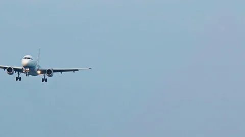 Passenger plane landing in the clear sky 스톡 동영상 74982170