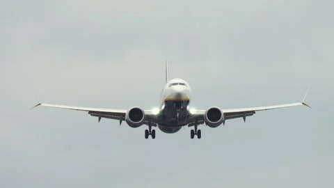 Passenger plane landing while banking in windy weather. Aircraft tilting Stock Footage 309626764