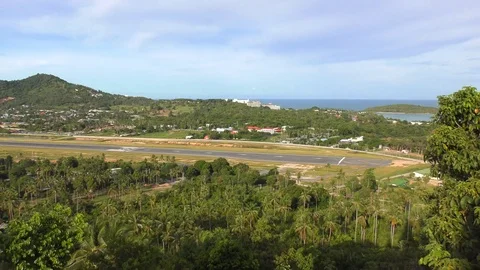 A Passenger Plane Lands on the runway of Tropical Island. Aircraft Land to the Stock Footage