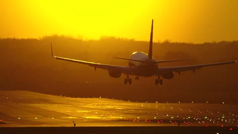 Passenger plane lands at sunset, showcasing travel excitement and adventure Stock Footage 303717042