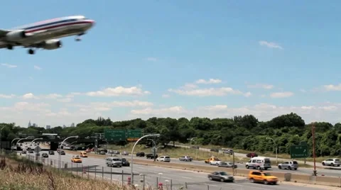 Passenger Plane low altitude fly by over freeway Stock Footage 11188947