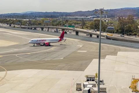 Passenger plane preparing for takeoff with a view of nearby roads and build.. Stock Photos