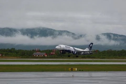 Passenger plane of the Russian airline Aurora on the runway during taxiing Stock Photos