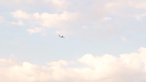 Passenger plane in the sky. Overhead flying aircraft landing at sunrise Stock Footage 249935902