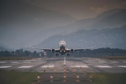 Passenger plane takes off front view against Stock Photos