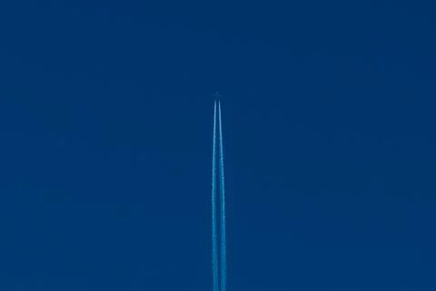 A passenger plane with two long white stripes of a reversible track in the bl Stock Photos