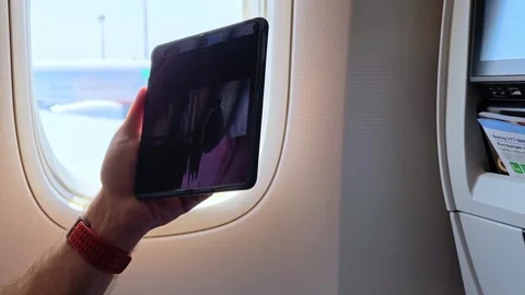 Passenger in the plane using mobile phone to see a film. Entertainment. Stock Footage 309930949