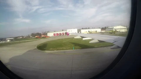 Passenger plane window POV on arrival at airport Stock Footage 73280644