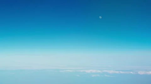 Passenger plane window seat view of Cumulus Clouds and Blue Sky Stock Footage 336736581