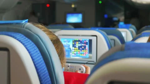 Passenger playing game during flight in 4k slow motion 60fps Stock Footage 145946599