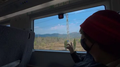 Passenger Pointing Out Train Window — Human Moment Framed by Yunnan Landscape Stock Footage 312588907