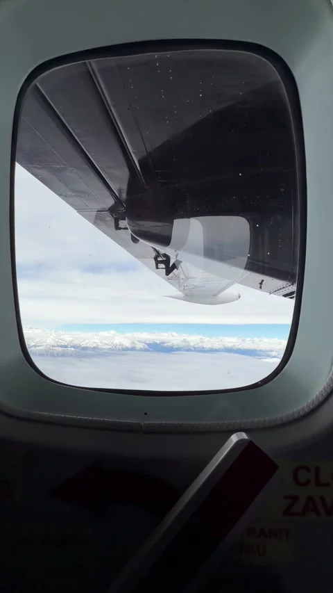 Passenger POV aircraft window framing black turboprop engine nacelle spinni.. Stock Footage 343553530