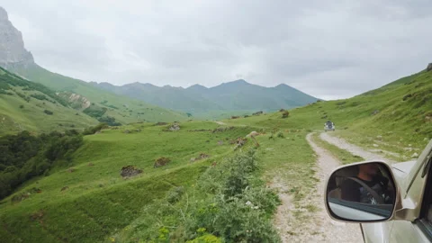 Passenger POV Side Mirror View Following SUV On Mountain Dirt Road Video stock 346890073