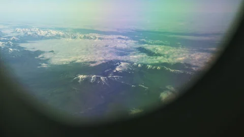 Passenger POV view from an airplane window flying above fluffy clouds Stock-Footage 336717948