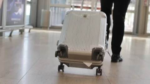 Passenger pulling trolley case through a... | Stock Video | Pond5