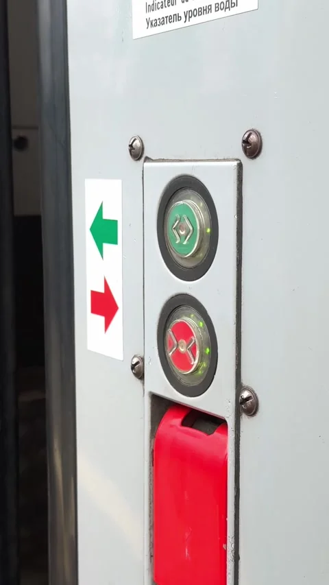 A passenger pushing a circular button to open train doors on a platform, 스톡 동영상 345830625