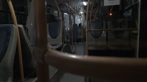 A passenger rides inside an empty public bus at night. Passenger transportation Stock Footage 303618133