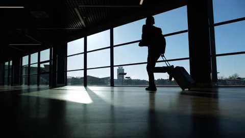 Passenger running at the airport terminal in hurry, slowmo shot Stock Footage 320117853