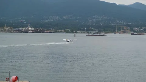Passenger seaplane taking off on a grey cloudy day Stock Footage 250580062