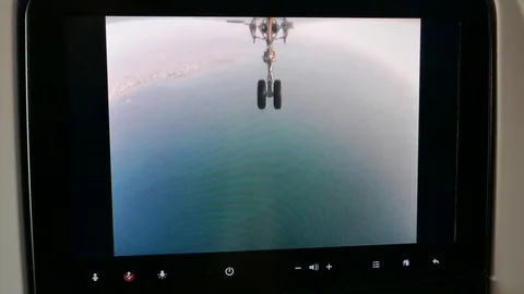 Passenger seat display airplane camera show landing gear opening before landing Stock Footage 112232913
