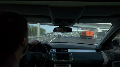 Passenger-seat view of driver navigating multi-lane urban highway under Stock Footage 339885986