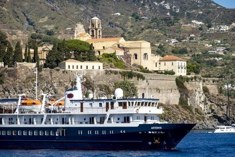 Passenger ship Artemis passes below the Lipari Castle Stock Photos