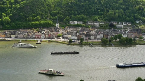 Passenger ship, barge and ferry on the river Rhine, with small town Stock Footage 38336002