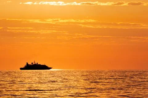 Passenger ship at sunset Stock Photos