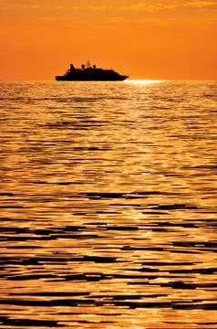 Passenger ship at sunset Stock Photos