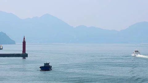 Passenger Ships Passing by a Lighthouse in Hiroshima Port, Seto Inland Sea, 4K Stock Footage 340830497
