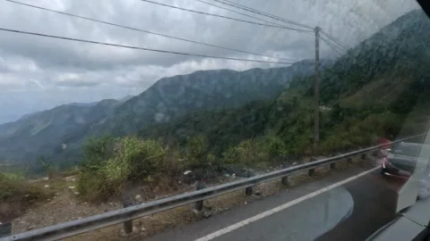 A passenger in sleeper bus with TV. Legs. Mountains view from a window Stock Footage 248679331
