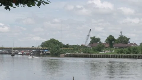 Passenger speedboat passing through old port of Banjarmasin Stock Footage 142122791