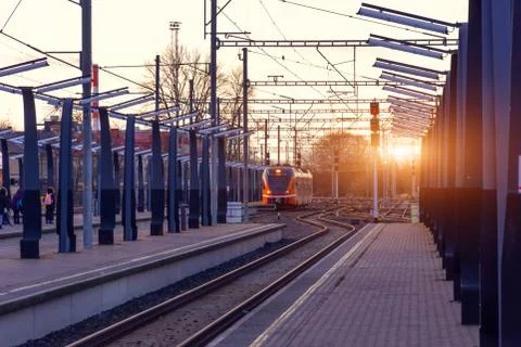 Passenger station with an empty platform without people, a train is visible i Stock-Fotos