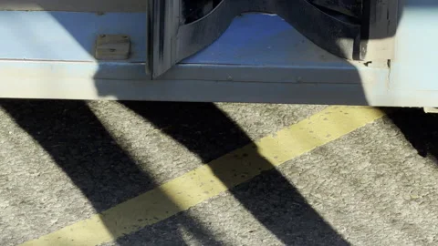 Passenger steps forward to board a public bus at a sunny city stop Stock Footage 336937379