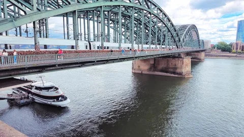 Passenger Train and Boat Beside Hohenzollern Bridge Stock Footage 345653306