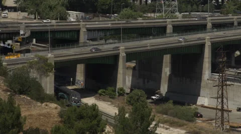 Passenger train and busy freeways Stock Footage