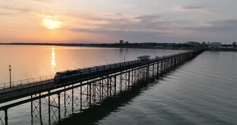 Passenger train and colourful sunset sky in background Stock-Footage 202232946