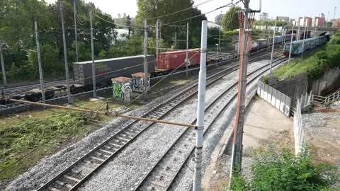 Passenger train and freight train run side by side Stock Footage 162184612