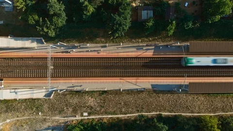 Passenger train approaching a train station - Top down aerial timelapse view Stock Footage 91711544
