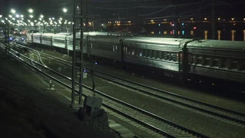Passenger train arrives at night Stock Footage 143310880