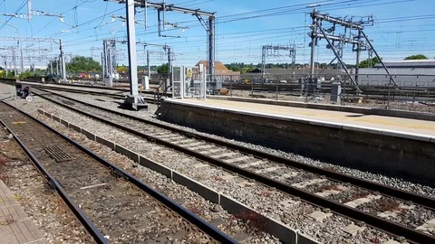 A passenger train arrives at a train station in England Stock Footage 111138418