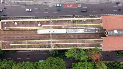 Passenger Train arriving and stopping at the platform, top down aerial view Stock Footage 219247251