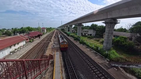 Passenger train arriving at local railway station in Ayutthaya. Stock Footage 343717399