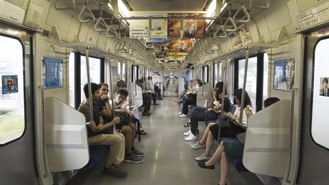 The passenger train car is inside. Metro passengers look into the phones. Video stock 91846294