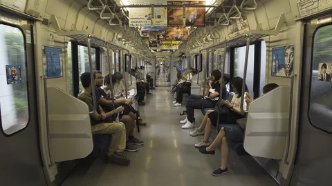 The passenger train car is inside. Metro passengers look into the phones. Stock Footage 91847123