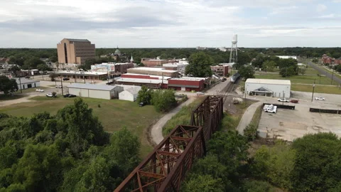 Passenger Train Crossing Bridge in Small Town in Texas USA Stock Footage 246831780