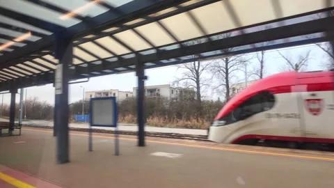 A passenger train departing from an urban platform, captured with motion blur Stock Footage 345669695