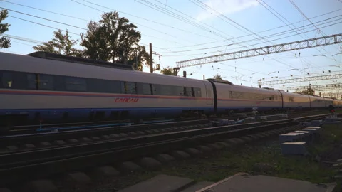 Passenger train fast running to the sunset Stock Footage 90131705