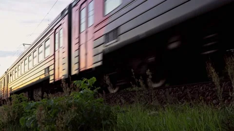 Passenger train fast running to the sunset Stock Footage 138566239