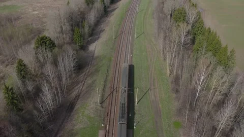Passenger Train Going Through spring fields and Forest, Aerial View. Stock Footage 190368337